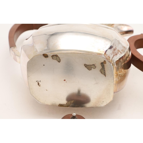 102 - AN ELIZABETH II SILVER TEA POT & MATCHING HOT WATER JUG. of shaped oblong form, with angular handles... 