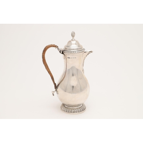 108 - A WORLD WAR II PERIOD SILVER HOT WATER JUG. of baluster form, with a cane insulated loop handle and ... 