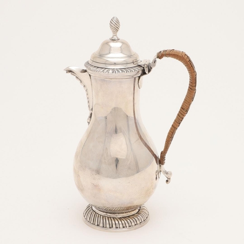 108 - A WORLD WAR II PERIOD SILVER HOT WATER JUG. of baluster form, with a cane insulated loop handle and ... 