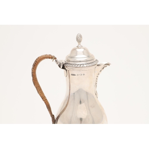 108 - A WORLD WAR II PERIOD SILVER HOT WATER JUG. of baluster form, with a cane insulated loop handle and ... 