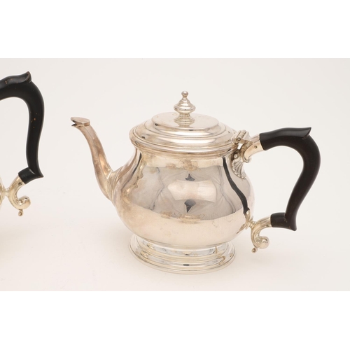 110 - A GEORGE VI FOUR-PIECE SILVER TEA SET. with oval baluster bodies, spreading oval feet & the hot wate... 