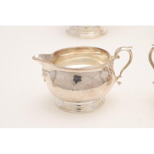 110 - A GEORGE VI FOUR-PIECE SILVER TEA SET. with oval baluster bodies, spreading oval feet & the hot wate... 