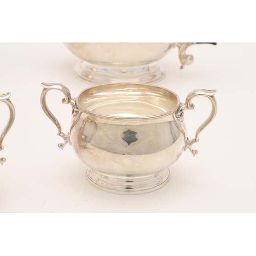 110 - A GEORGE VI FOUR-PIECE SILVER TEA SET. with oval baluster bodies, spreading oval feet & the hot wate... 