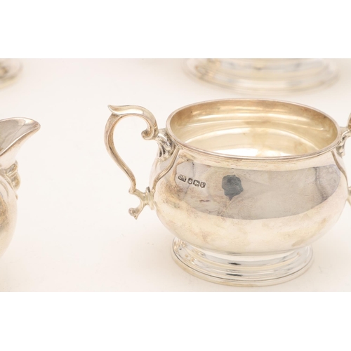 110 - A GEORGE VI FOUR-PIECE SILVER TEA SET. with oval baluster bodies, spreading oval feet & the hot wate... 