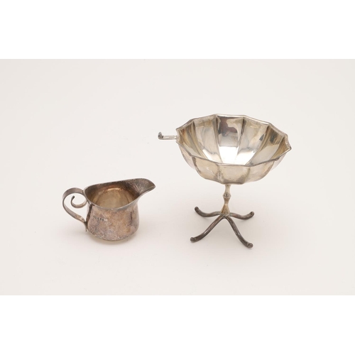 113 - AN EDWARDIAN ART-NOUVEAU BRITANNIA-STANDARD SILVER CREAM JUG. with a scroll handle and a spot hammer... 