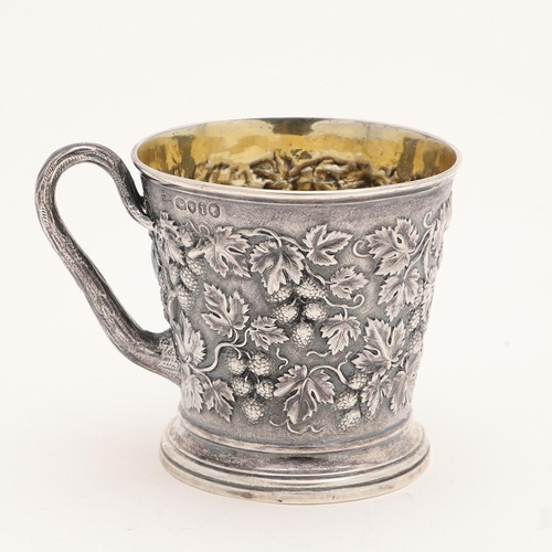 118 - A VICTORIAN SILVER MUG. tapering circular form, with a naturalistic handle and  embossed with fruiti... 