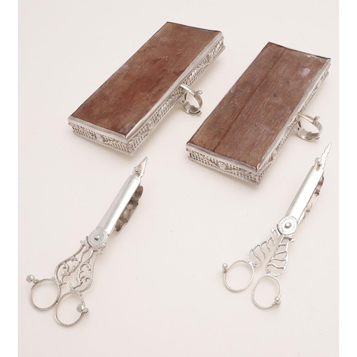 121 - A PAIR OF GEORGE III WOODEN MOUNTED SILVER SNUFFER TRAYS. rectangular form, with pierced sides, embo... 