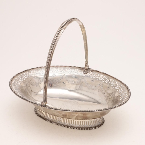 125 - A GEORGE III SILVER SWING-HANDLE CAKE BASKET. oval outline, with bead borders, the edges and foot wi... 