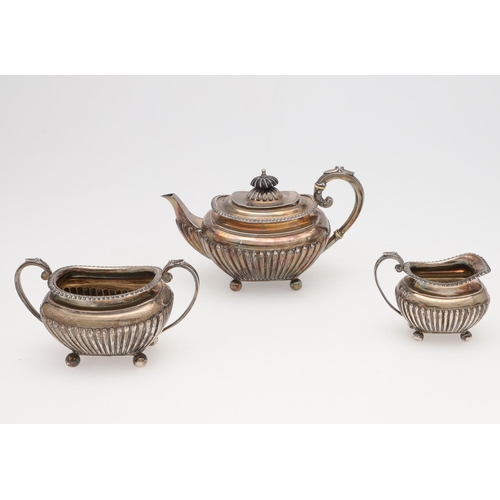 133 - A LATE VICTORIAN SMALL OR BACHELOR'S THREE-PIECE SILVER TEA SET. rounded rectangular, with tongue & ... 