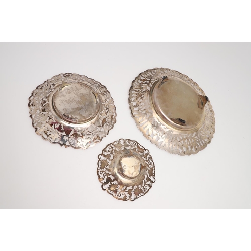 137 - 20TH CENTURY EGYPTIAN SILVER. three dishes & a swing-handle basket, all with pierced floral decorati... 