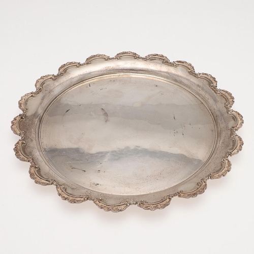 138 - A 20TH CENTURY EGYPTIAN SILVER SALVER OR TRAY. of shaped circular outline and with a scroll border, ... 