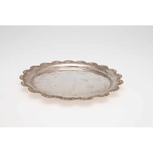 138 - A 20TH CENTURY EGYPTIAN SILVER SALVER OR TRAY. of shaped circular outline and with a scroll border, ... 