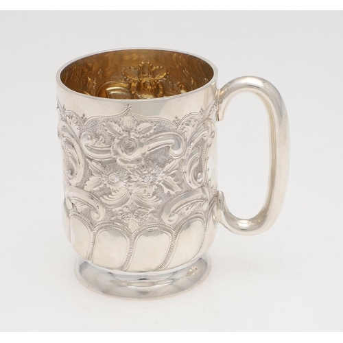 141 - A VICTORIAN SILVER MUG. circular form, embossed & chased with foliate scroll decoration and a vacant... 