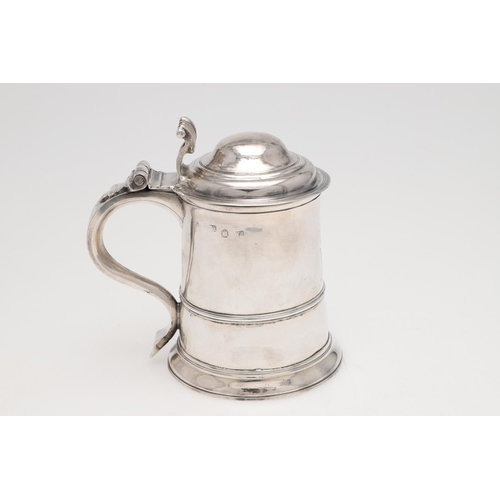 143 - A GEORGE II LADY'S SILVER TANKARD. tapering circular form, with an applied moulded girdle, a scroll ... 