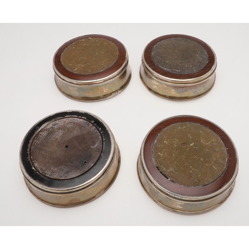 147 - A SET OF FOUR GEORGE III SILVER WINE COASTERS. with slightly everting rims, reeded borders and turne... 