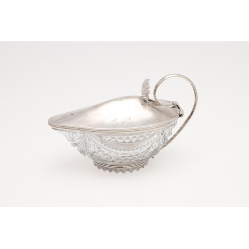 157 - A GEORGE III SILVER MOUNTED CUT-GLASS JUG. with reeded borders, a scroll handle and a shell thumbpie... 