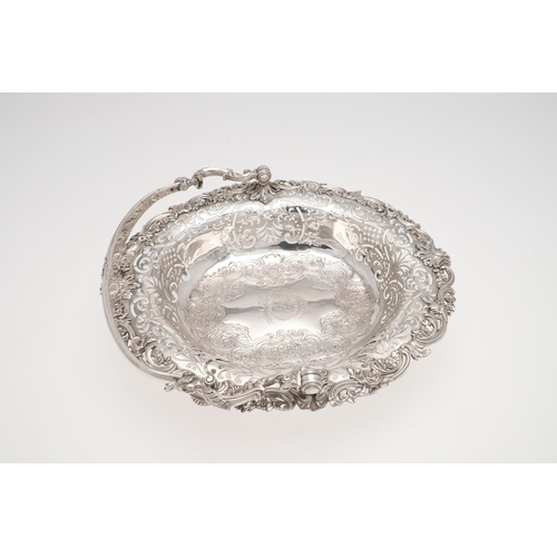 161 - A GEORGE II SWING-HANDLE SILVER CAKE BASKET. with a flat-chased centre, applied floral scroll border... 