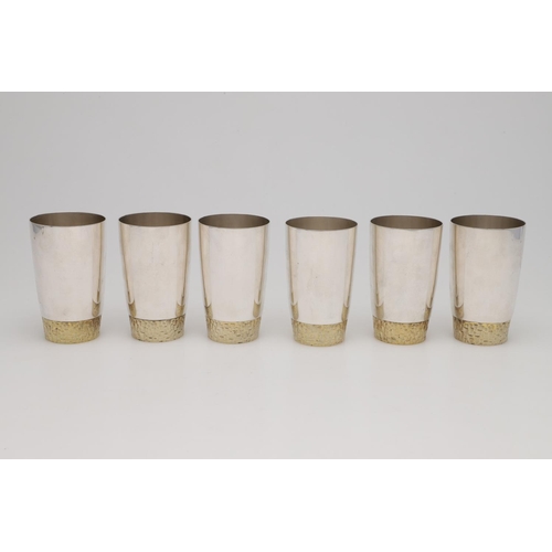 165 - A SET OF SIX ELIZABETH II PARCELGILT TUMBLERS, BY STUART DEVLIN. circular and with textured bases, L... 