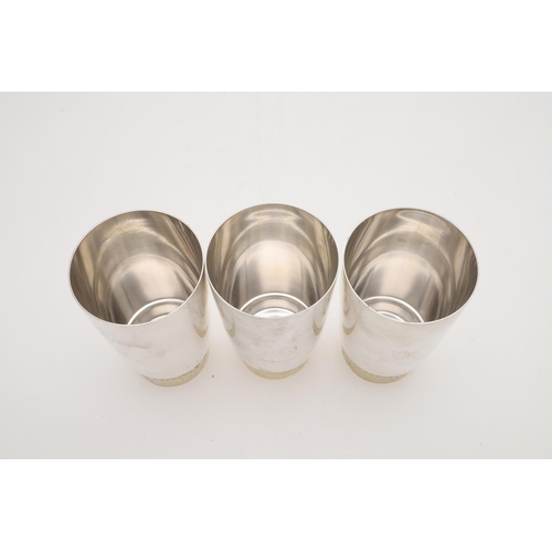 165 - A SET OF SIX ELIZABETH II PARCELGILT TUMBLERS, BY STUART DEVLIN. circular and with textured bases, L... 