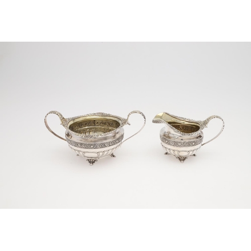 172 - A GEORGE III THREE-PIECE SILVER TEA SET. squat circular form, with gadroon & shell borders, wrythen ... 