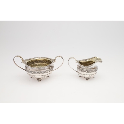 172 - A GEORGE III THREE-PIECE SILVER TEA SET. squat circular form, with gadroon & shell borders, wrythen ... 