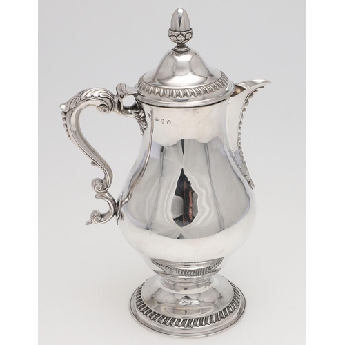 173 - A GEORGE III BALUSTER IRISH SILVER EWER OR JUG. with an acorn finial, a leaf-capped scroll handle an... 