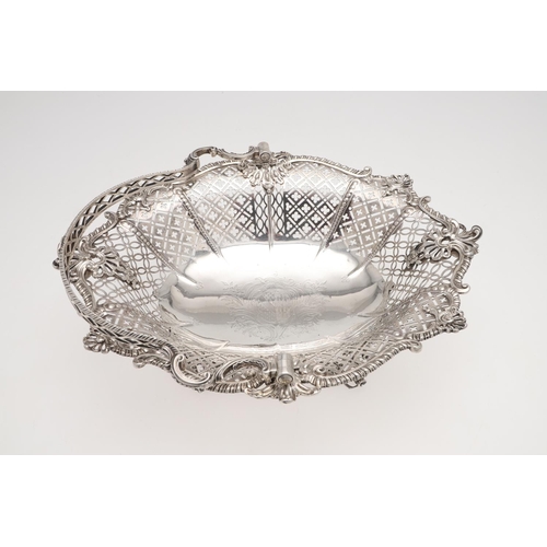 176 - A GEORGE III SWING-HANDLE SILVER CAKE BASKET. shaped oval outline, with a gadrooned border with alte... 