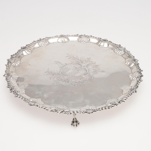 178 - A GEORGE III SILVER SALVER. shaped circular outline, with a gadroon & shell border, engraved arms to... 