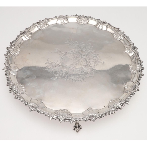 178 - A GEORGE III SILVER SALVER. shaped circular outline, with a gadroon & shell border, engraved arms to... 