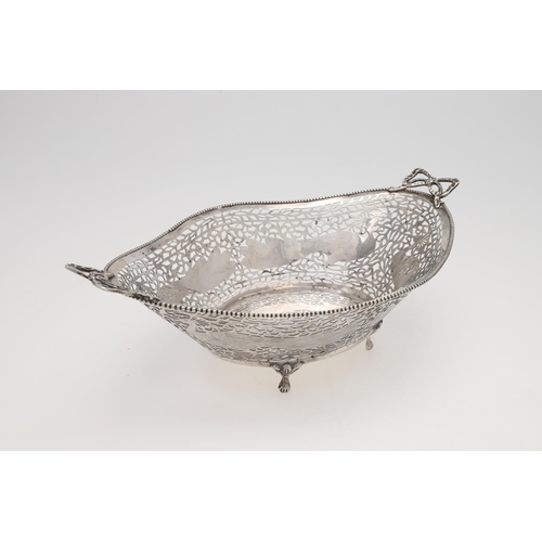 179 - AN EARLY 20TH CENTURY DUTCH SILVER BASKET. shaped oval outline, with twin ribbon-tied handles, bead ... 