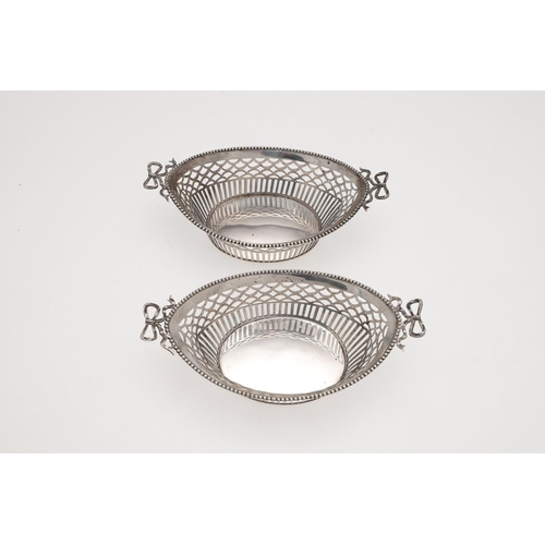 179 - AN EARLY 20TH CENTURY DUTCH SILVER BASKET. shaped oval outline, with twin ribbon-tied handles, bead ... 