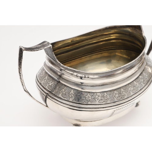 182 - A GEORGE III THREE-PIECE SILVER TEA SET. rounded oblong form, with engraved borders, a central friez... 