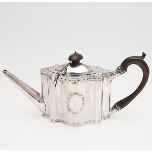 183 - A GEORGE III BRIGHT-CUT ENGRAVED SILVER TEA POT. shaped oval form, with a 'C'-scroll handle and a va... 