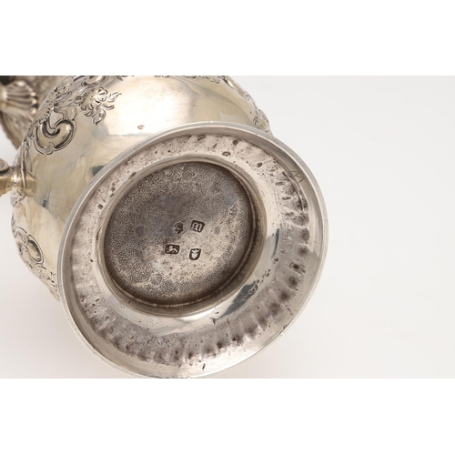 185 - A GEORGE III SILVER COFFEE POT. baluster form, with embossed & chased decoration, a scroll handle an... 