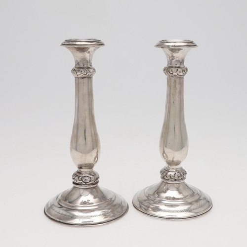 186 - A PAIR OF 19TH CENTURY AUSTRIAN SILVER CANDLESTICKS. with baluster columns and embossed & chased bor... 