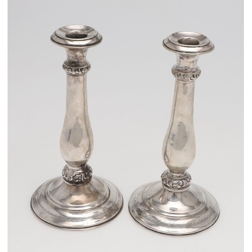 186 - A PAIR OF 19TH CENTURY AUSTRIAN SILVER CANDLESTICKS. with baluster columns and embossed & chased bor... 