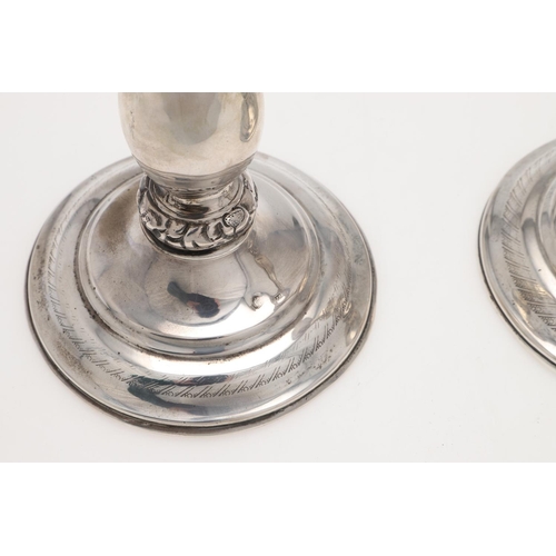 186 - A PAIR OF 19TH CENTURY AUSTRIAN SILVER CANDLESTICKS. with baluster columns and embossed & chased bor... 