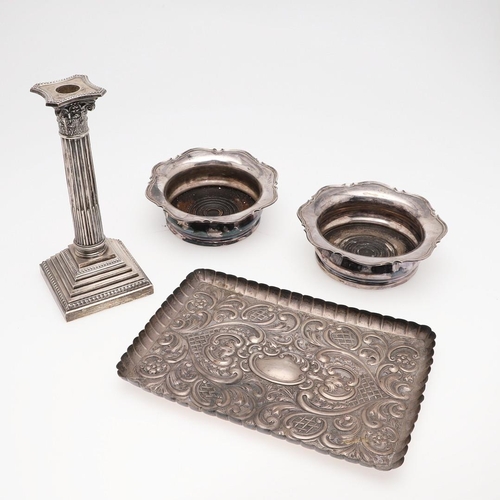 187 - A PAIR OF EARLY 20TH CENTURY SILVER MOUNTED WINE COASTERS. shaped circular outline, with a moulded b... 