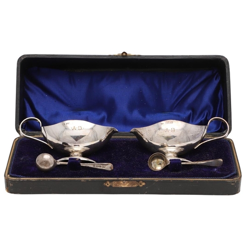 191 - A CASED PAIR OF SILVER SALTS & MATCHING SPOONS. in the form of sauce boats, initialled on one side 