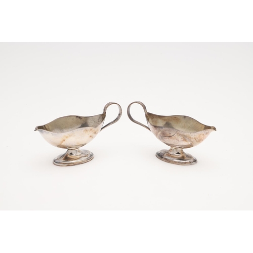 191 - A CASED PAIR OF SILVER SALTS & MATCHING SPOONS. in the form of sauce boats, initialled on one side 