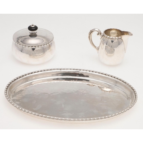 193 - AN EARLY 20TH CENTURY THREE-PIECE CONTINENTAL SILVER SUGAR & CREAM SET. with a spot-hammered finish,... 