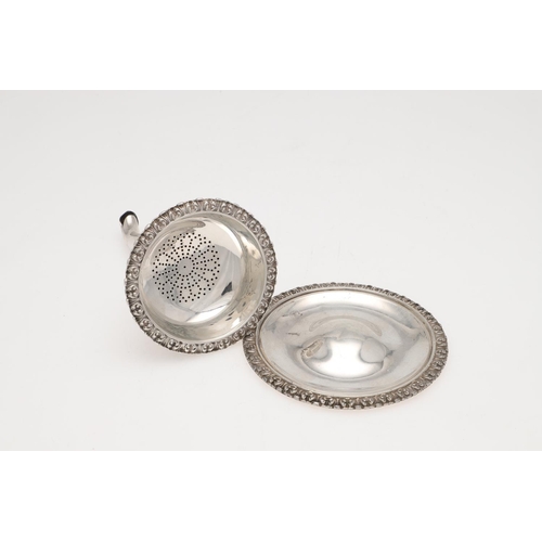 195 - A GEORGE IV SCOTTISH SILVER WINE FUNNEL. with a foliate border, a ribbed spout and a shell side clip... 