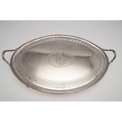 202 - A GEORGE III LARGE BRIGHT-ENGRAVED SILVER TEA TRAY. oval outline, with twin handles, the centre with... 