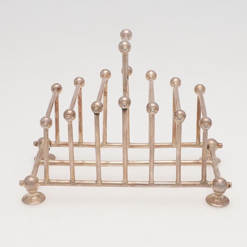 208 - A LATE VICTORIAN SILVER TOAST RACK. in the style of Christopher Dresser, with six divisions, straigh... 