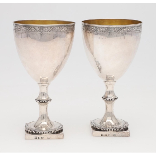 210 - A PAIR OF GEORGE III SILVER WINE GOBLETS, BY HESTER BATEMAN. on square pedestal bases, with bead bor... 