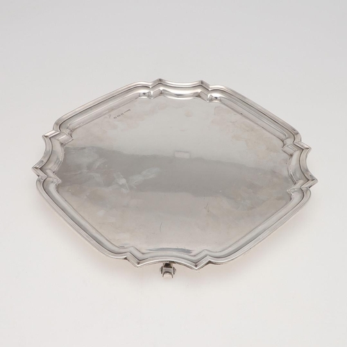 218 - A GEORGE V SILVER SALVER. shaped square outline, with a moulded border and on four scroll feet, by B... 