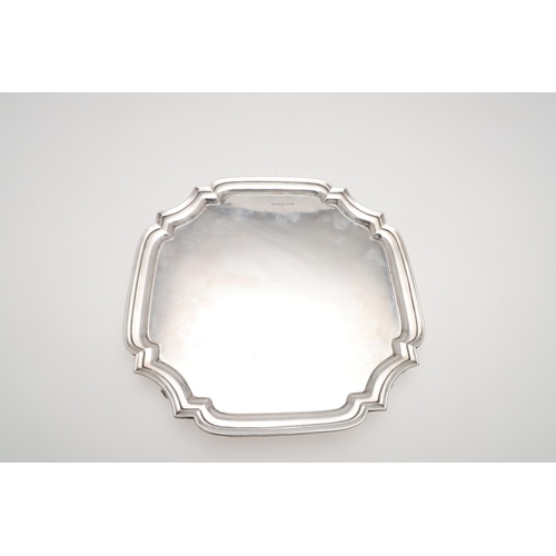 218 - A GEORGE V SILVER SALVER. shaped square outline, with a moulded border and on four scroll feet, by B... 