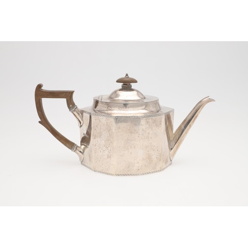 228 - A GEORGE V SILVER TEA POT. shaped decagon outline, with bright-cut borders and a wooden handle & fin... 