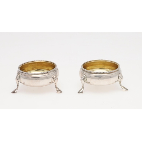 232 - A PAIR OF GEORGE III SQUAT CIRCULAR SILVER SALTS, BY HESTER BATEMAN. with corded borders and hoof fe... 