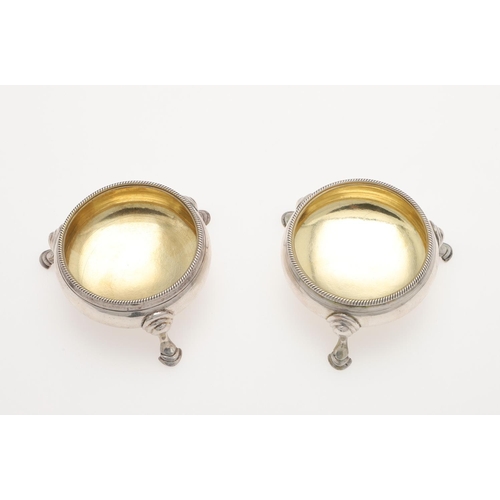 232 - A PAIR OF GEORGE III SQUAT CIRCULAR SILVER SALTS, BY HESTER BATEMAN. with corded borders and hoof fe... 